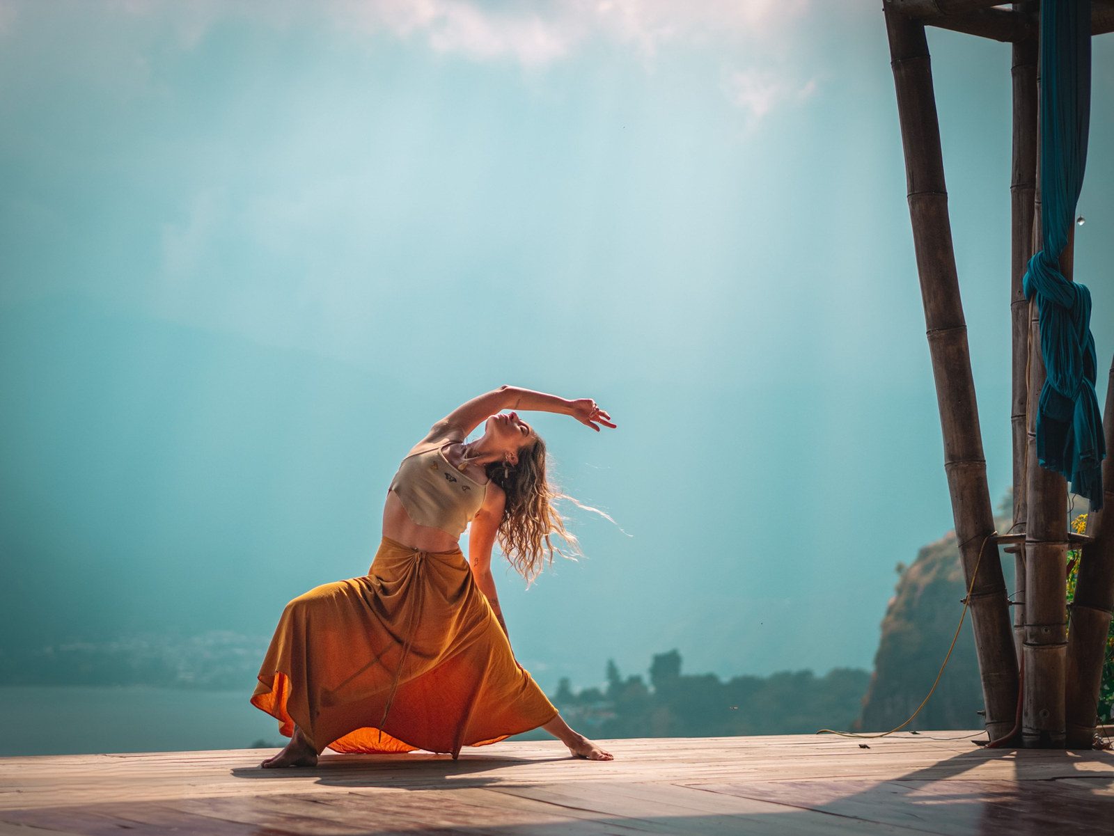 Chrystee dancing on a rooftop against a teal sky