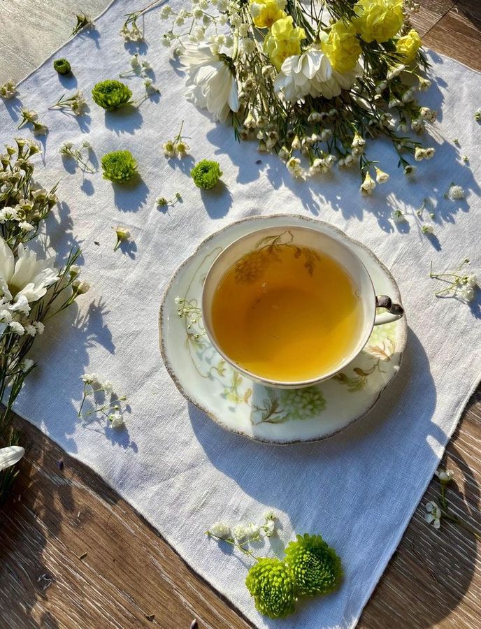 A cup of herbal tea surrounded by dried flowers