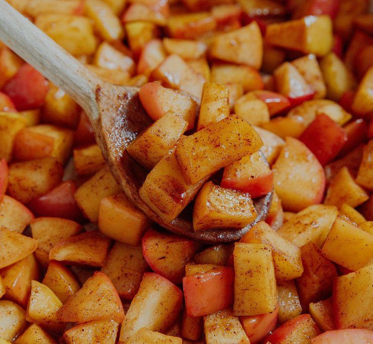 Stewed apples with cinnamon in a pan