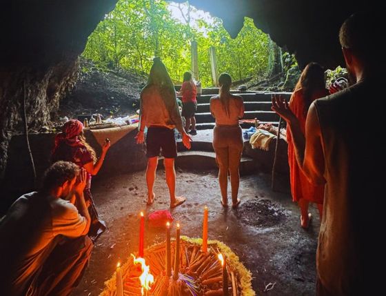 A candlelit ceremony inside an ancient Mayan cave